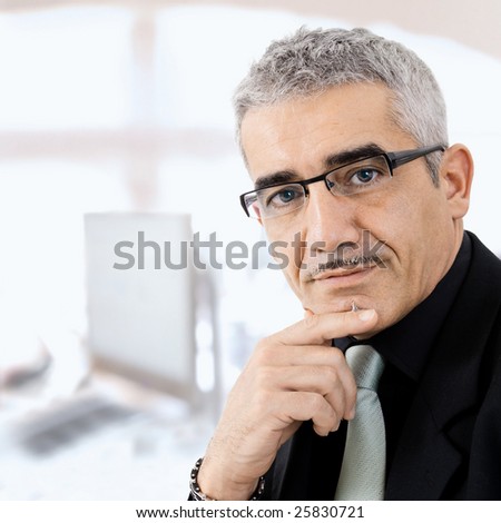 Mature gray haired creative looking businessman thinking.