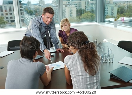 Group of young business people talking on business meeting at office.