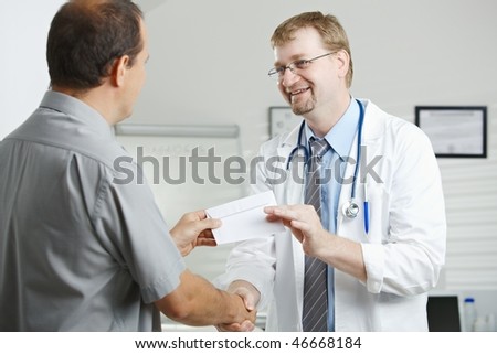 Medical office - patient bribing doctor, giving money in envelope.