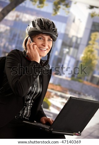 bike helmet front. stock photo : Portrait of young businesswoman wearing ike helmet, sitting in front of office