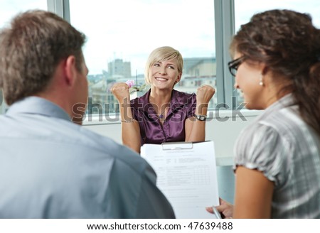 Happy woman applicant got the job by a successful job interview. Over the shoulder view.