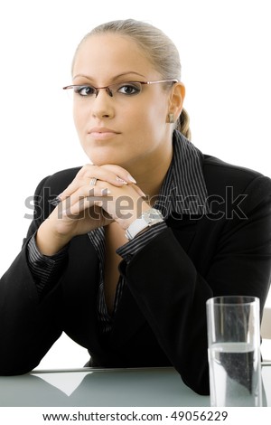 Young attractive businesswoman working at at desk, thinking, isolated on white background.