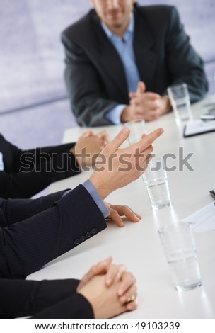 Closeup of hands on business meeting at office, businessman explaining to others.