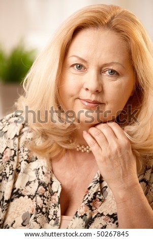 stock photo Portrait of mature blonde woman smiling at camera 