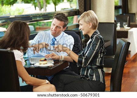 Young businessman and businesswomen having a meeting in cafe.