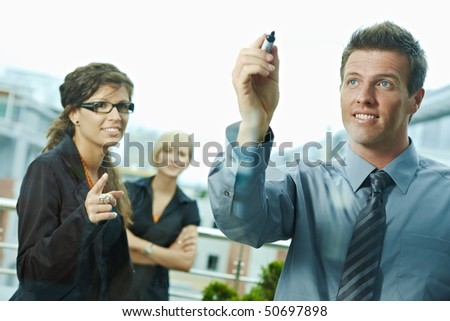 Business team planning, businessman thinking drawing diagram on window. Outdoor of office on terrace.