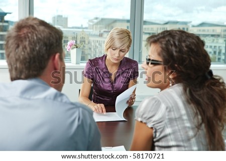 Team of casual looking business people having business meeting at office.