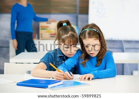 stock photo : Children learning together in primary school classroom.