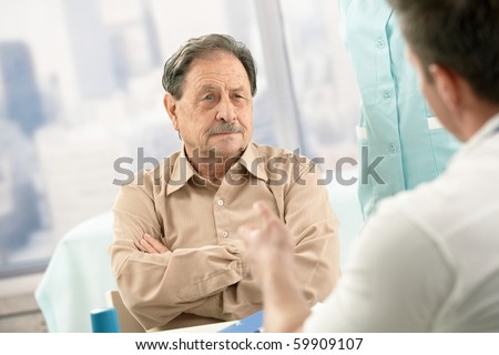 Senior patient listening to doctor\'s explanation on consultation.?