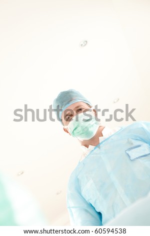 Portrait of medical professional wearing uniform and mask, looking at camera.?
