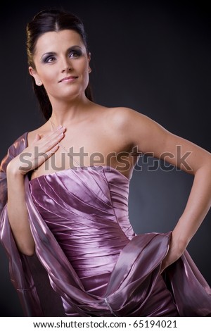 Beautiful young woman posing, wearing a light purple evening dress with stole.?