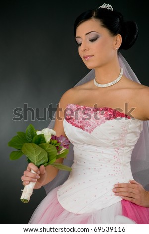 stock photo Beautiful young bride in white and pink wedding dress looking 