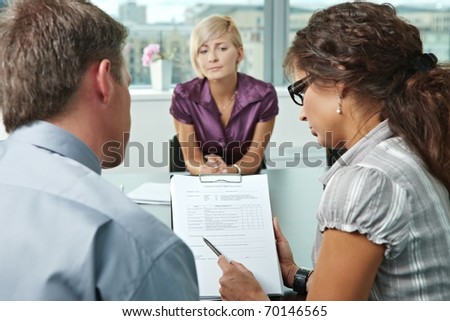 Woman applicant worrying during job interview. Over the shoulder view. Focus placed on sheet in front results are good.?