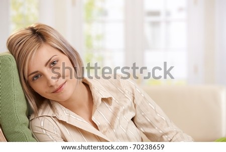 Portrait of happy casual woman resting at home looking at camera, smiling.?