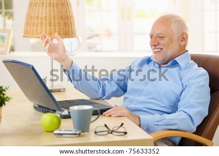 stock-photo-laughing-old-man-using-lapto