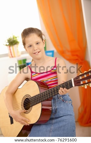 Portrait of young guitar player, smiling at camera.?