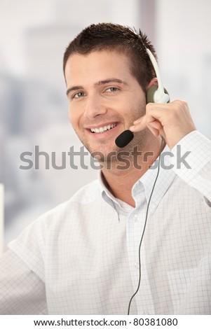 Portrait of happy customer service operator working in bright office.?