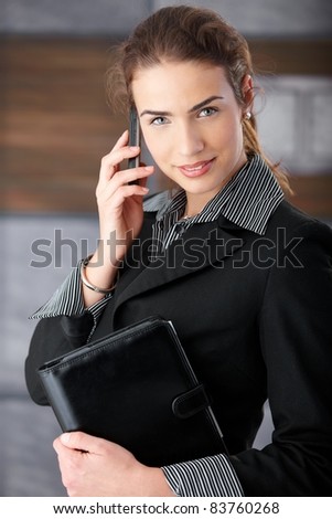 Beautiful elegant woman chatting on mobile phone, smiling.?