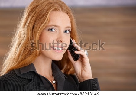 Closeup facial portrait of happy businesswoman on mobile phone call, looking at camera.?