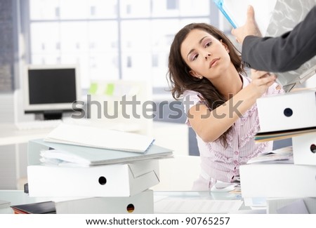 Desperate female office worker getting new folders to deal with.?