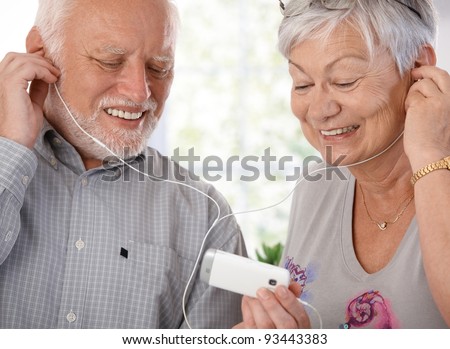 stock-photo-happy-elderly-couple-using-mp-player-listening-to-music-smiling-93443383.jpg