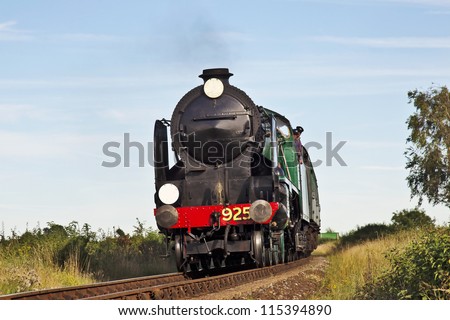 ROPLEY, UK - SEPTEMBER 8: Ex Southern Schools class locomotive, Cheltenham, approaches Arlesford Hill with a train of passengers at the MHR autumn steam gala on September 8, 2012 at Ropley
