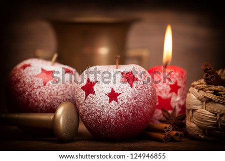Burning Christmas candles with cinnamon sticks.