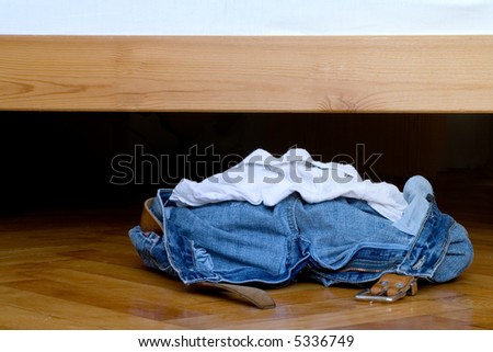 A pile of clothes laying on the floor.