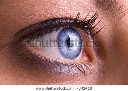 A woman\'s beautiful sky blue eye, made up with mascara and eye shadow.