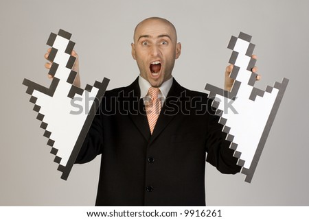 A businessman looks shocked as he holds two mouse-pointers/arrows (pointing downwards).