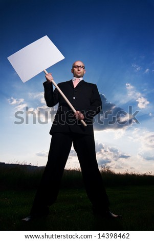 Businessman standing holding a blank sign.  Room for copy. Available space for text.