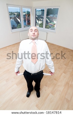 A broke man showing his empty pockets.