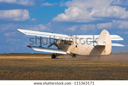 old airplane takes off on the field