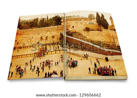 An opened old book with a picture Western Wall,Temple Mount, Jerusalem, Israel. Photo in old color image style on white background