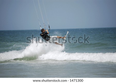A kitesurfer launches into the air off a breaker at Ponce Inlet Beach, Florida