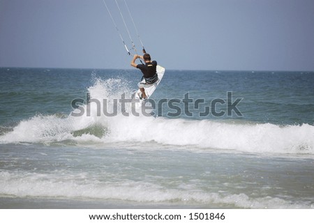 A kitesurfer launches into the air off a breaker on Ponce Inlet Beach, Florida