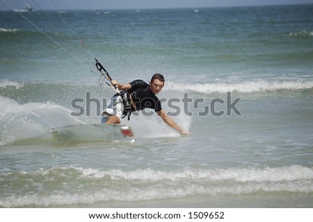 A kitesurfer concentrates intensely as he approaches the beach at Ponce Inlet Beach, Florida