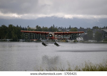 A float plane takes off from a lake in Anchorage Alaska