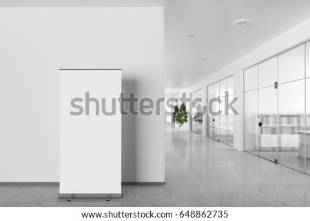 Blank roll up banner stand in bright office interior with clipping path around ad stand. 3d illustration