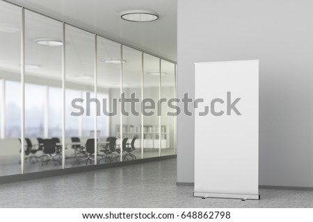 Blank roll up banner stand in bright office interior with clipping path around ad banner. 3d illustration