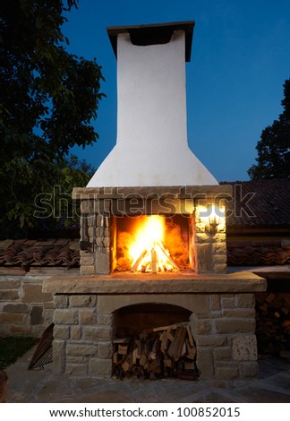 Fireplace in rural house backyard, barbecue grill for roasting food