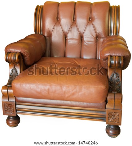 Old wood and leader-made armchair with hand-made woodcarvings, isolated with a clipping path