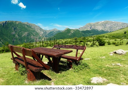 Table and seats at the trail to Botev peak, the high mountains of the Bulgarian Balkans