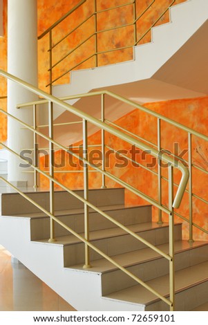 Stairs in villa with orange color walls