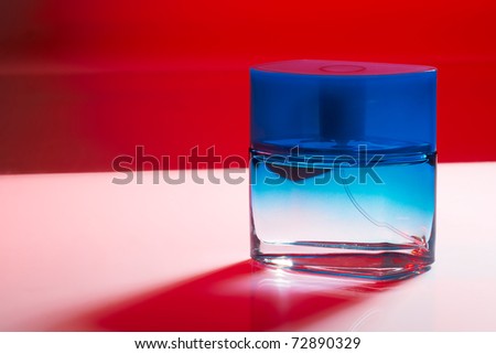 Blue perfume bottle on purple background with red shadow