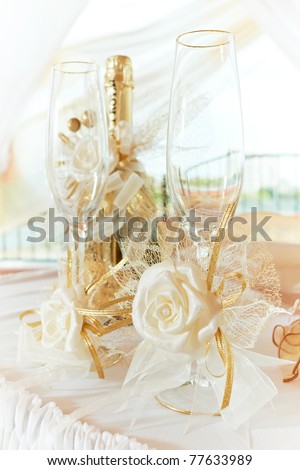 stock photo Two wedding glasses with decoration and champagne wine bottle
