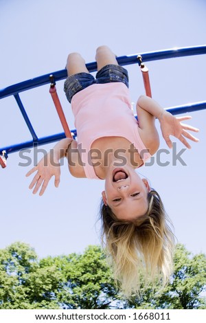 Model Release 254  Eleven year old girl playing on gym bars in park