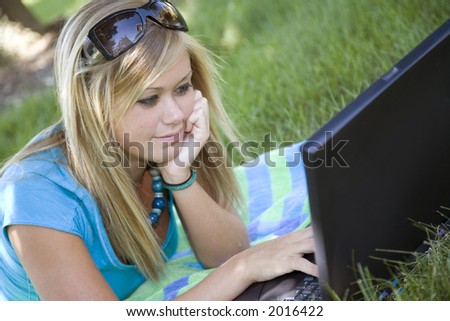 Model Release 358  Teenage girl working on laptop computer outdoors