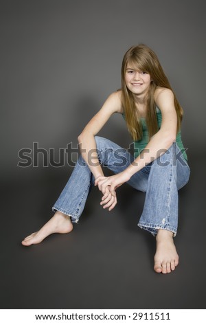 Preteen girl posing on gray background with some attitude