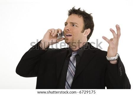Caucasian businessman standing and talking on the cell phone and angry
